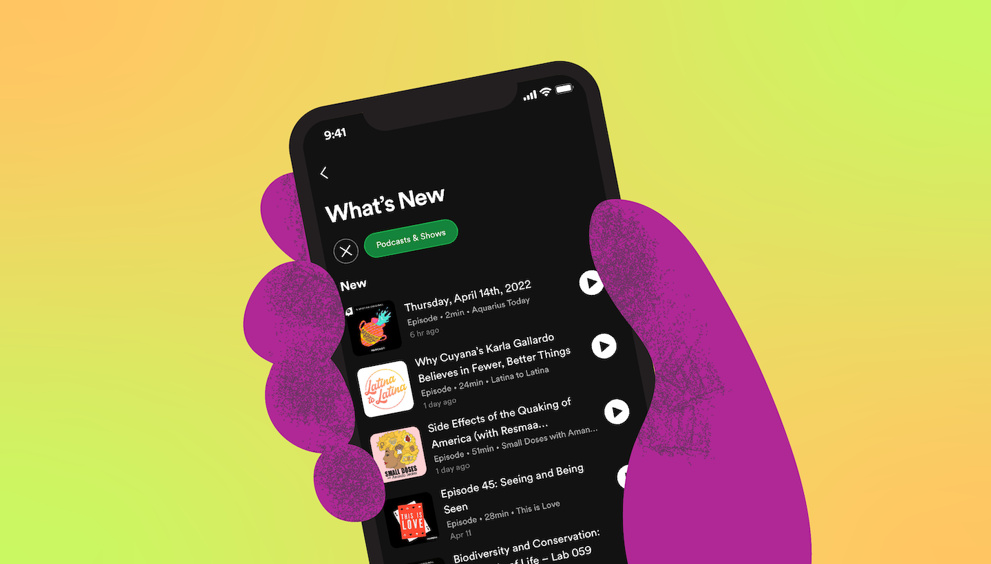 Purple hand holds a phone displaying podcast What's New feed on Spotify