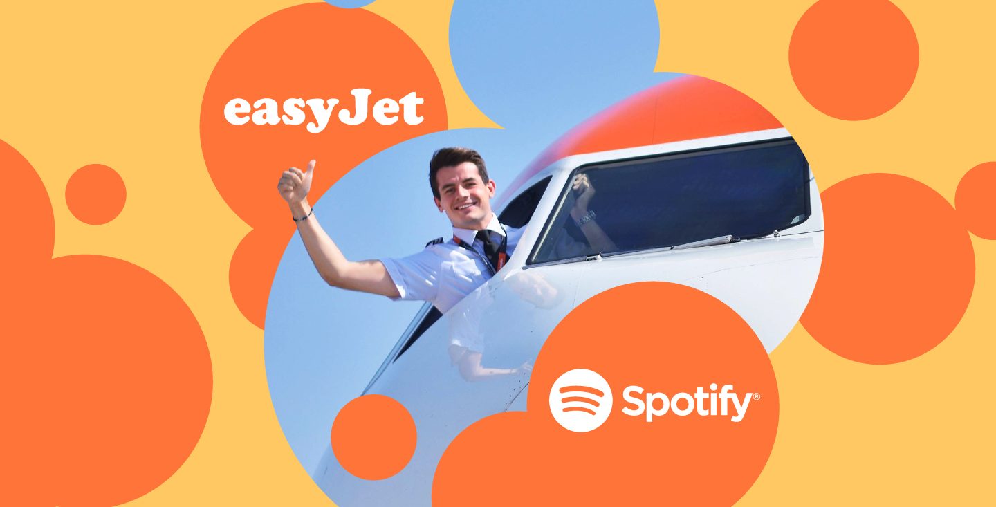 a pilot is waving out of a plane and there are graphic orange circles around him