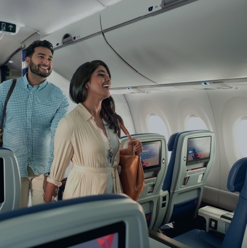 A man and a woman boarding a delta flight