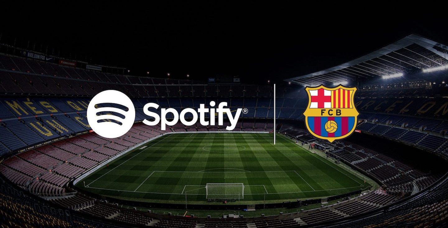 Spotify and FC Barcelona logos on dimly lit pitch background