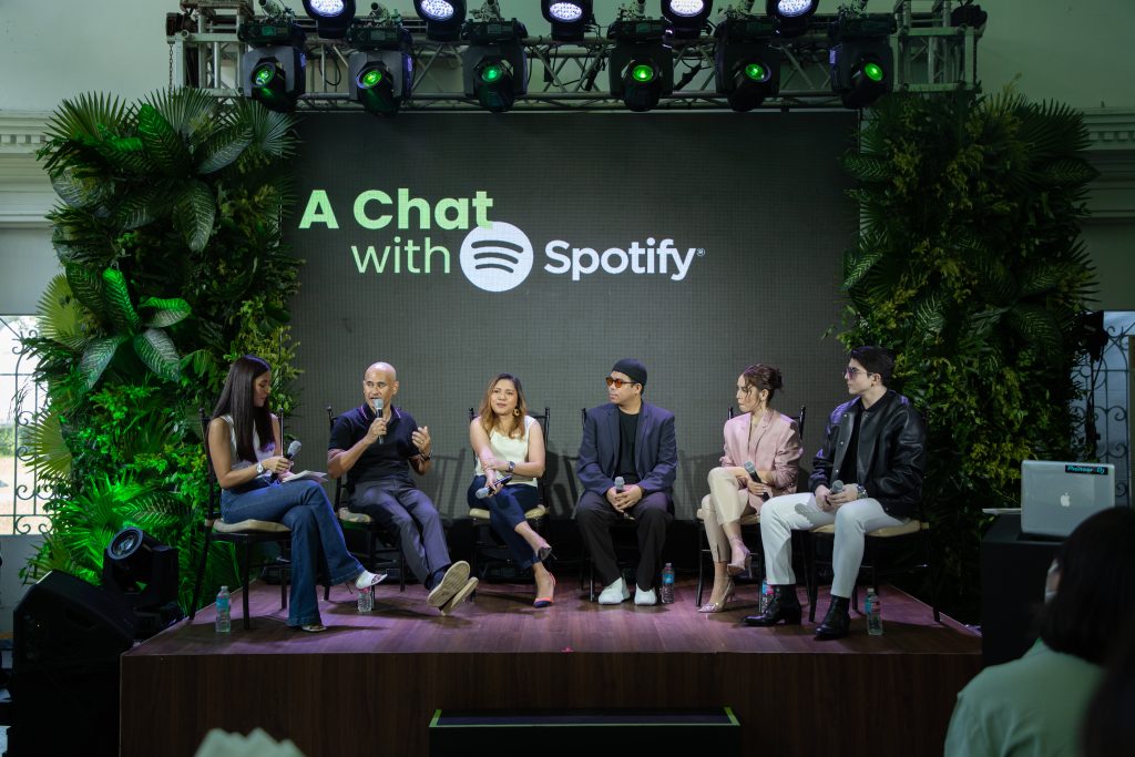 a photo of participants sitting on stage speaking at a spotify panel