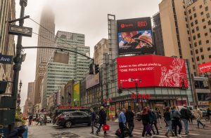 A photo of a billboard advertising the One Piece Film: Red Spotify playlist outside of Penn Station in New York City