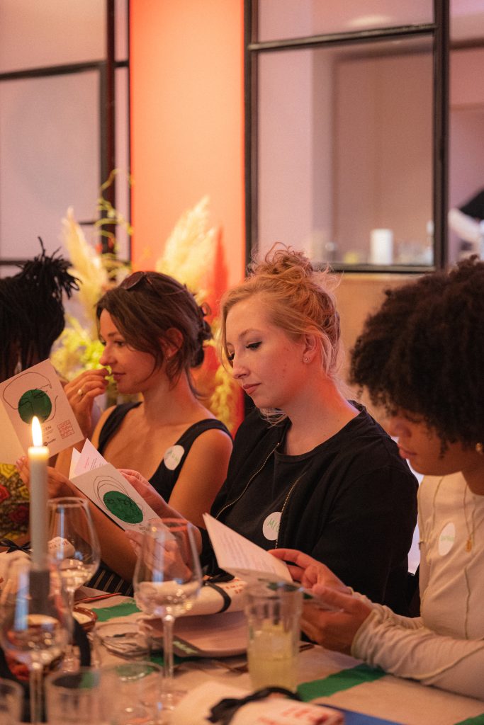 Women sitting at the dinner table reading a menu