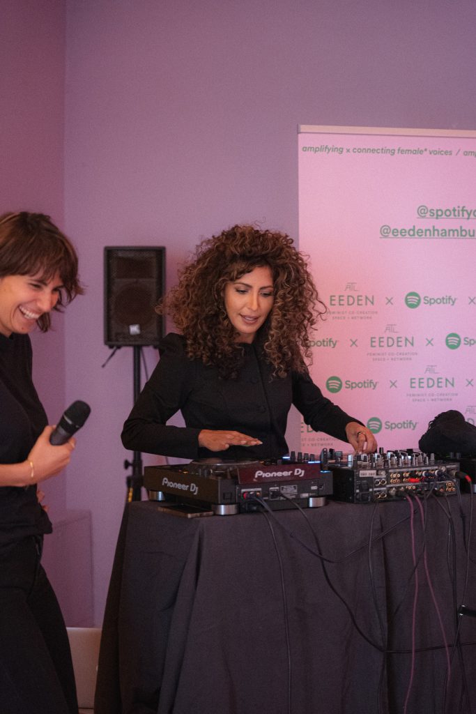 Woman performing at a DJ booth at the equalizer dinner in Germany