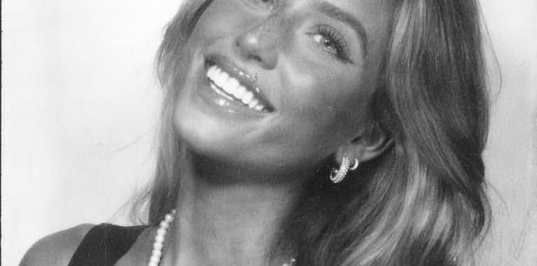 a black and white photo of Alix Earle smiling at the camera