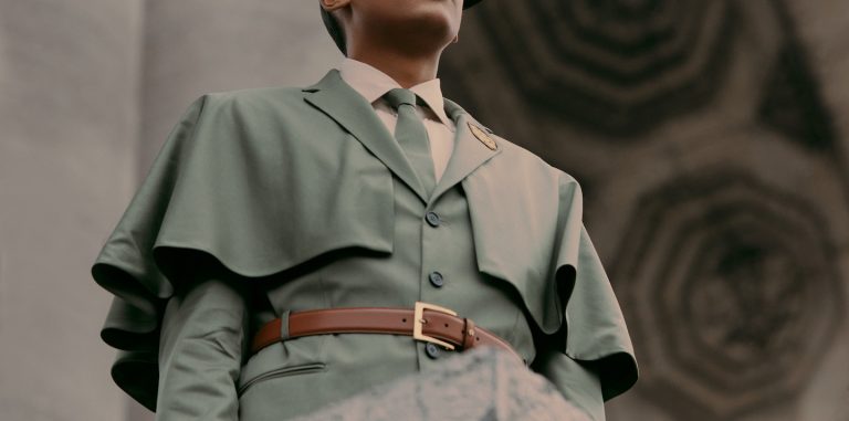 a photo of stromae standing on a platform looking out at a crowd