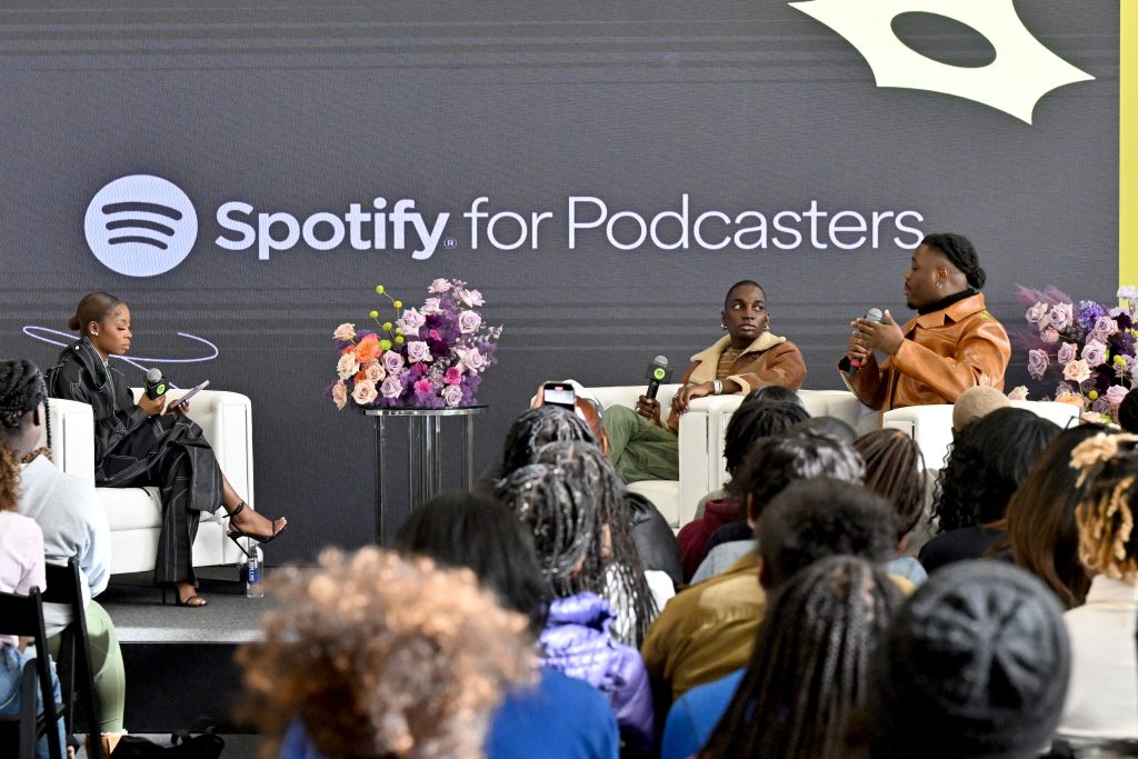 ATLANTA, GEORGIA - MARCH 20: (L-R) Host Wunmi Bello, Rickey Thompson, co-host of 'We Said What We Said', Spotify, and Denzel Dion, co-host of 'We Said What We Said', Spotify, speak onstage during Spotify NextGen Creator Day at Spelman College on March 20, 2023 in Atlanta, Georgia. (Photo by Paras Griffin/Getty Images for Spotify)