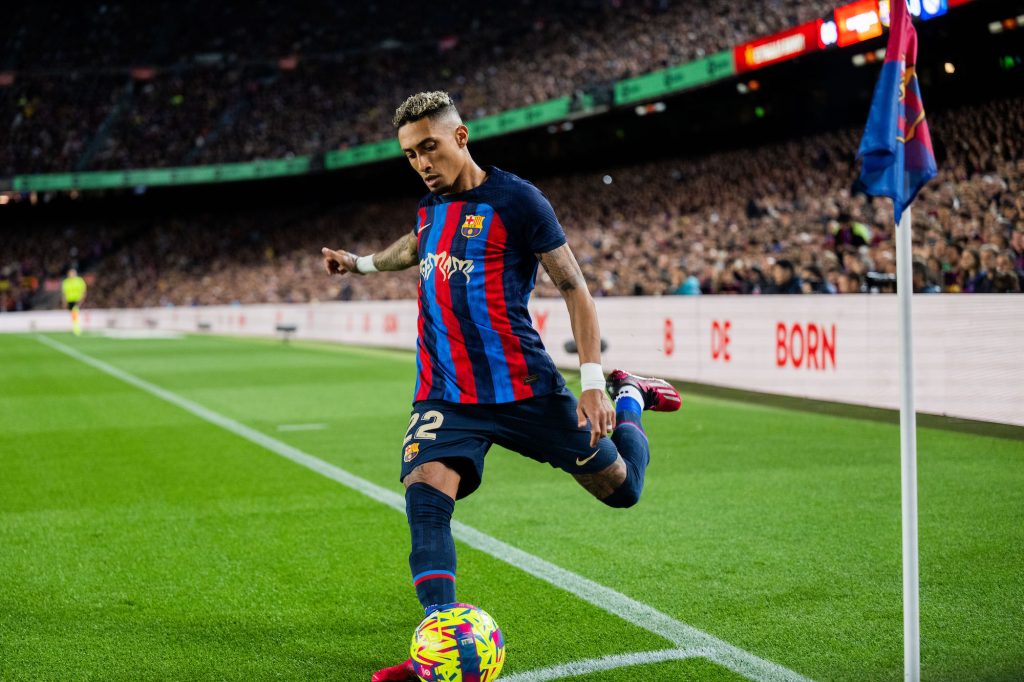 an fc barcelona player prepares to kick the ball