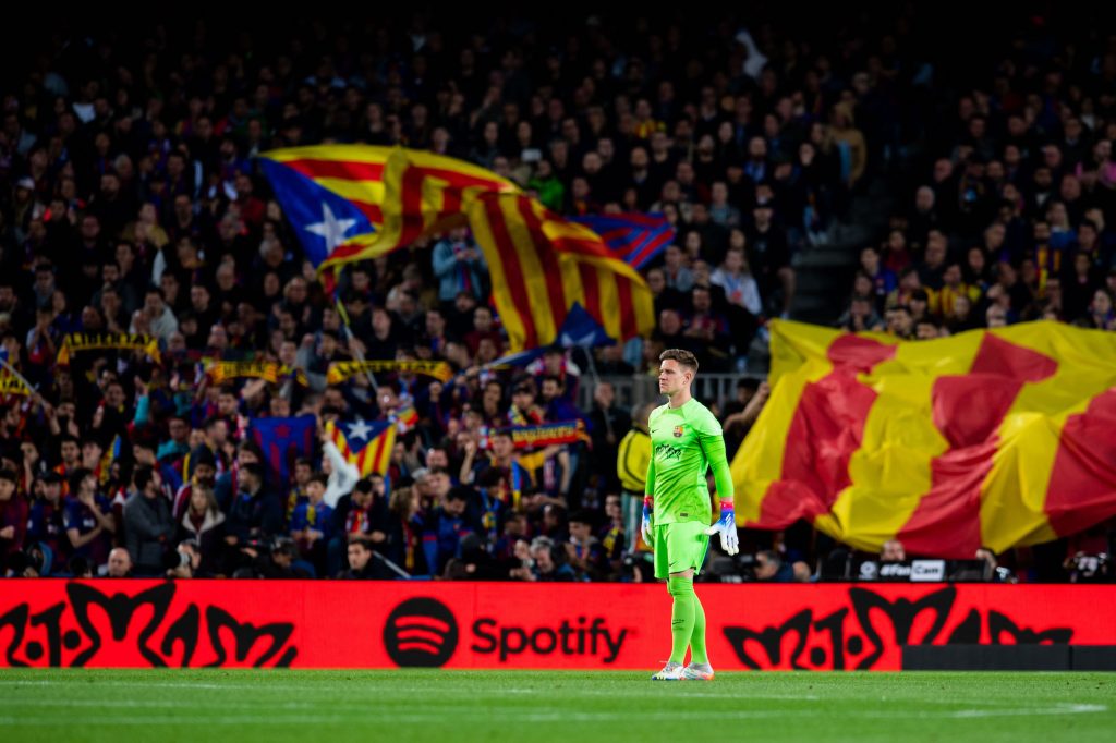 an fc barcelona player watches the field