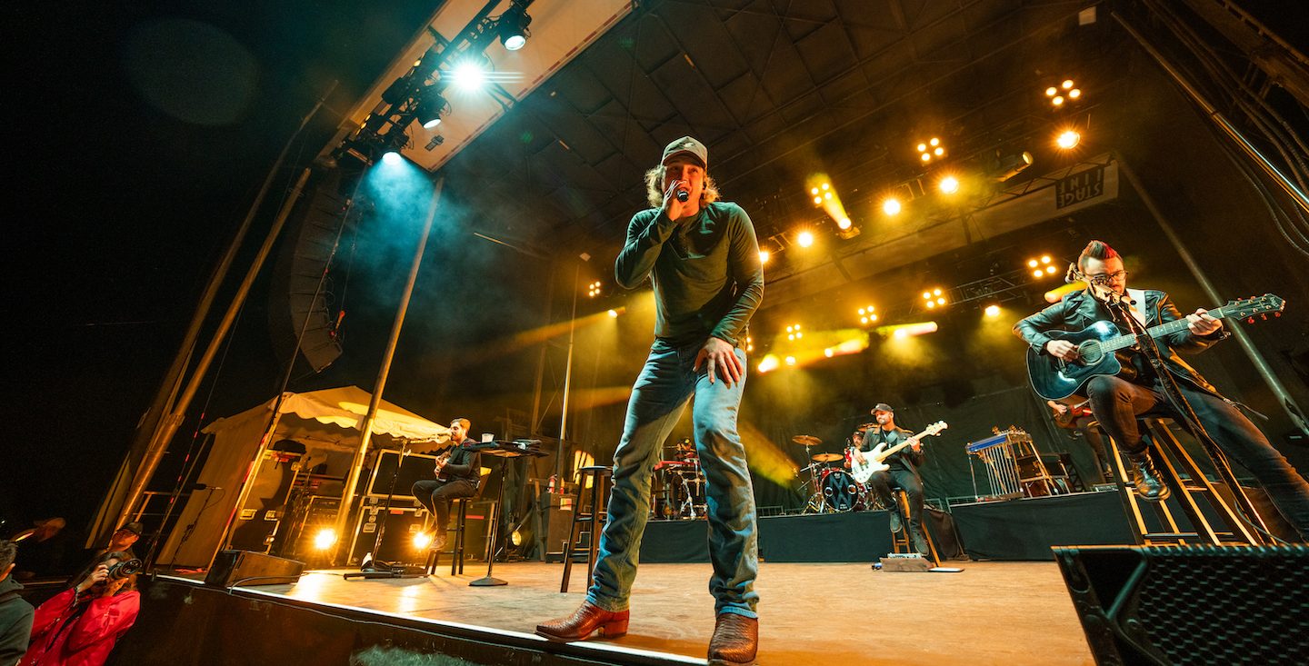 Morgan Wallen performing onstage at a show