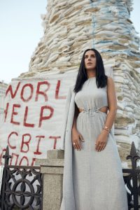 Jamala stands near a protest sign