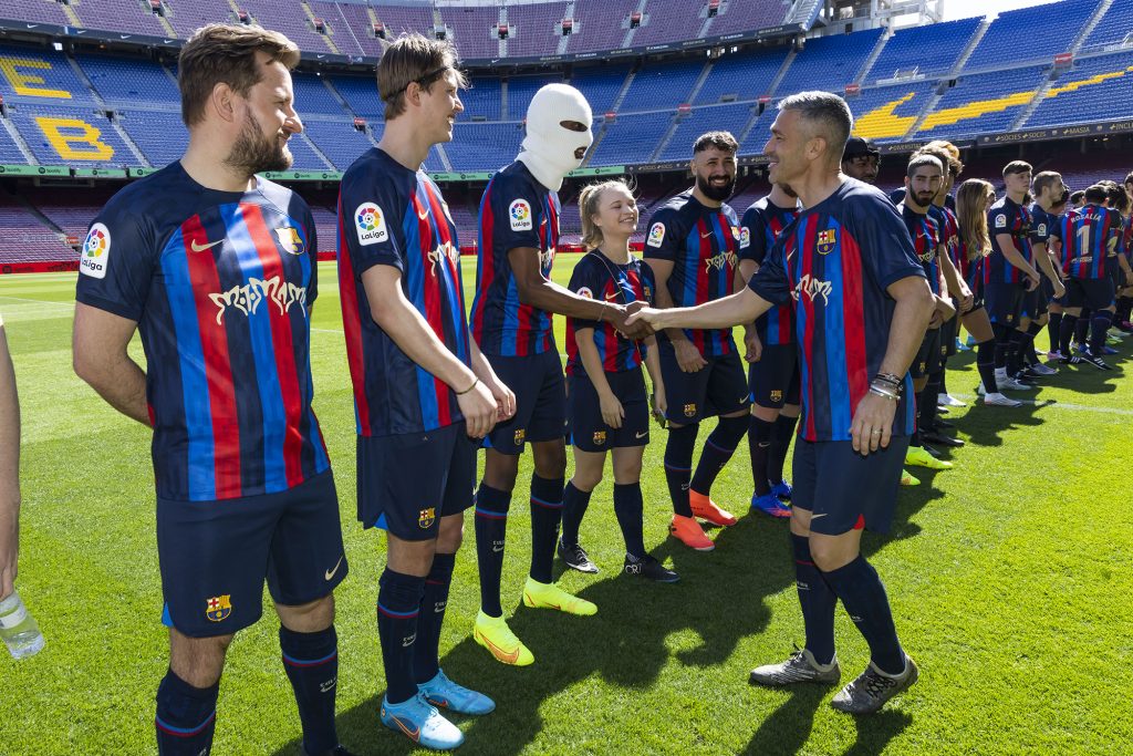 players are lined up on the field shaking the hand of Luis Garcia