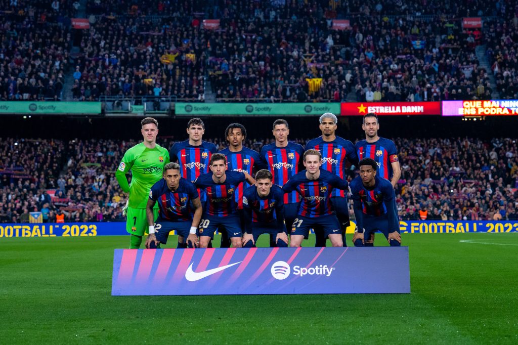 the FC Barcelona team posing on the field