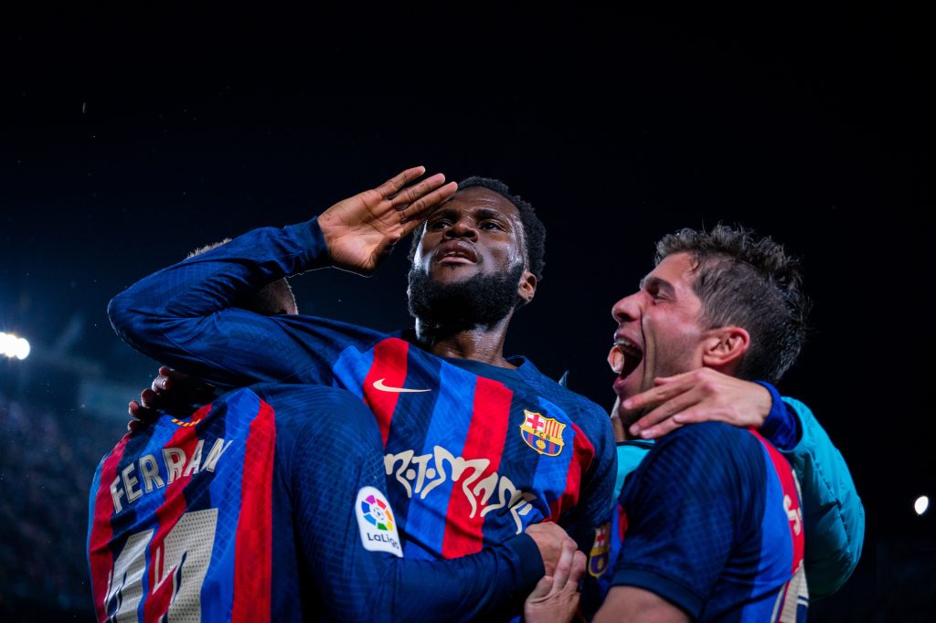 two fc barcelona players celebrating on field