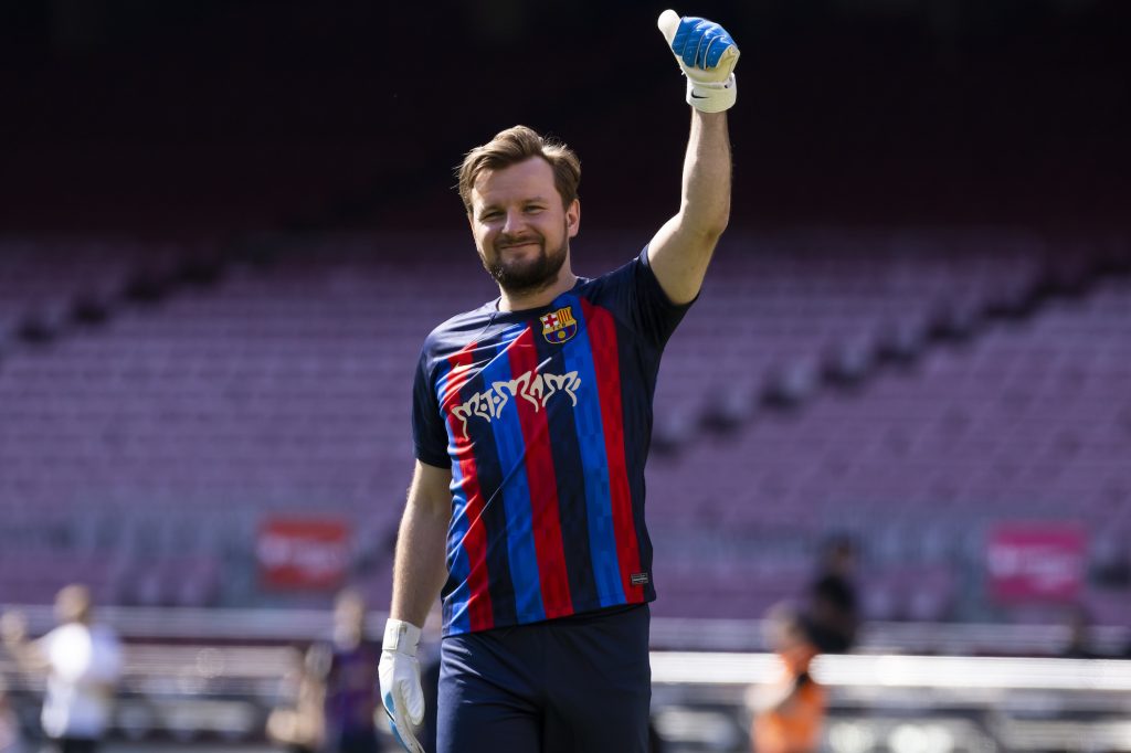 a man standing on the field gives a thumbs up