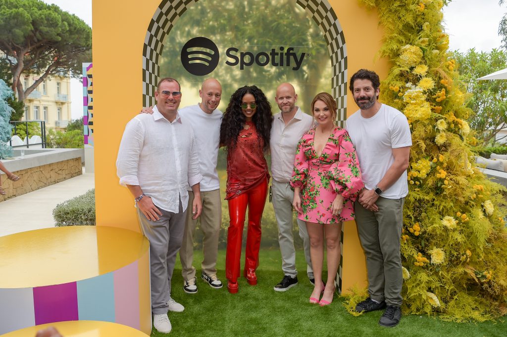 CANNES, FRANCE - JUNE 19: (L to R) Lee Brown, Spotify Global Head of Advertising, Alex Norström, Spotify Co-President &amp; Chief Business Officer, H.E.R., Daniel Ek, Spotify Chief Executive Officer, Dustee Jenkins, Spotify Chief Public Affairs Officer and Jeremy Erlich, Spotify Global Head of Music attend Spotify's intimate evening of music and culture during Cannes Lions 2023 at Villa Golda on June 19, 2023 in Cannes, France. (Photo by Antony Jones/Getty Images for Spotify)