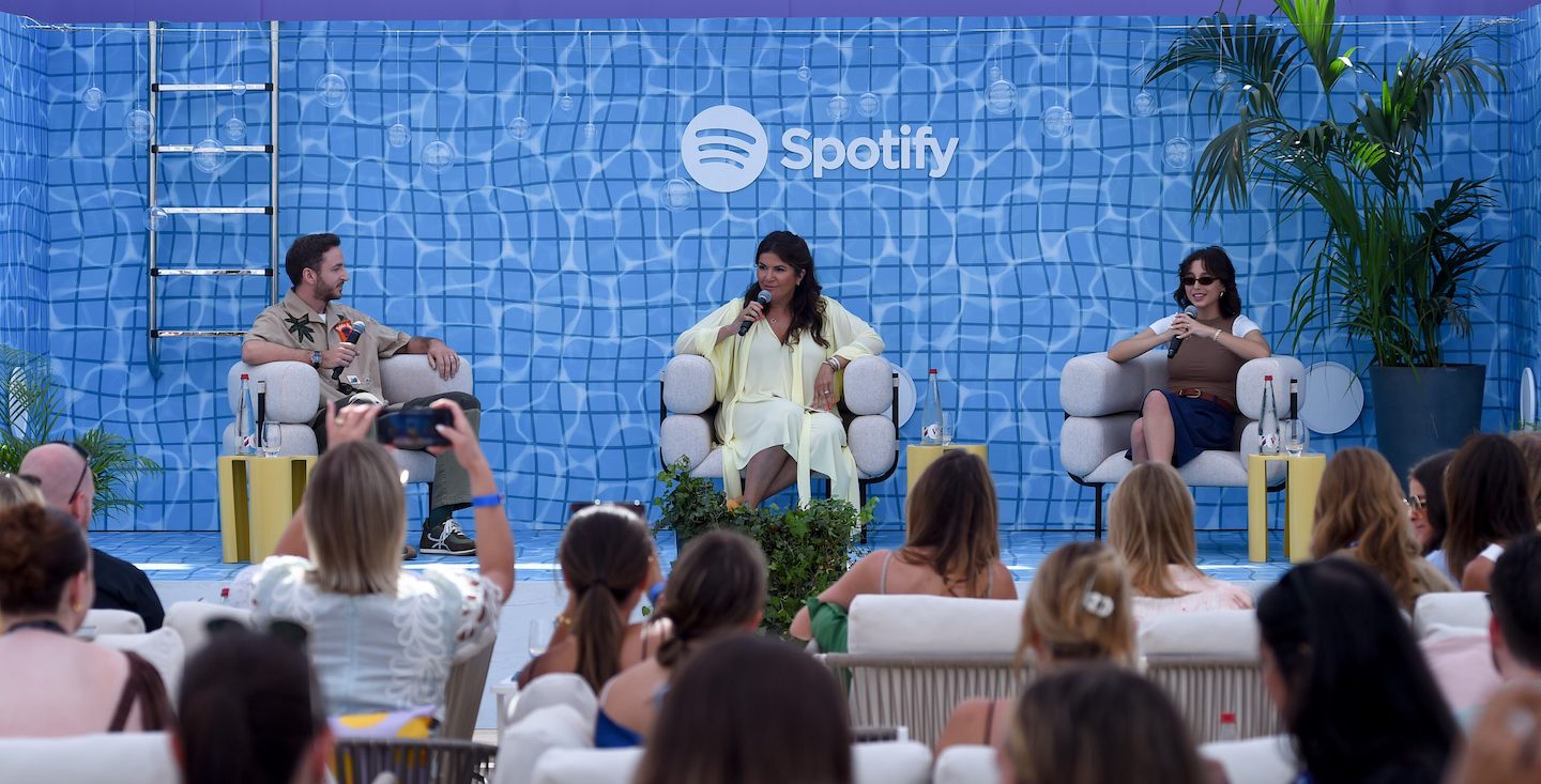 CANNES, FRANCE - JUNE 19: (L-R) Charlie Smith, CMO, Loewe, Taj Alavi, VP, Global Head of Marketing, Spotify and Emma Chamberlain, Creator of 'Anything Goes' onstage during the Spotify Beach At Cannes Lions 2023 Session: Building a Brand is More than Meets the Eye… And Ear on June 19, 2023 in Cannes, France. (Photo by Antony Jones/Getty Images for Spotify)