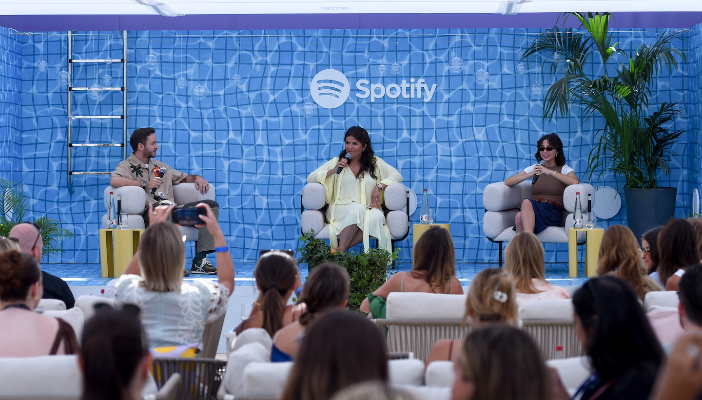 CANNES, FRANCE - JUNE 19: (L-R) Charlie Smith, CMO, Loewe, Taj Alavi, VP, Global Head of Marketing, Spotify and Emma Chamberlain, Creator of 'Anything Goes' onstage during the Spotify Beach At Cannes Lions 2023 Session: Building a Brand is More than Meets the Eye… And Ear on June 19, 2023 in Cannes, France. (Photo by Antony Jones/Getty Images for Spotify)
