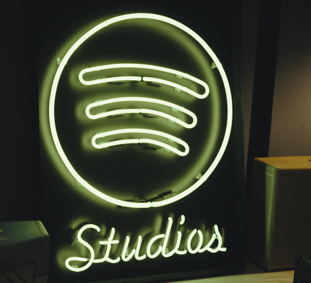 a neon sign showing spotify studios logo