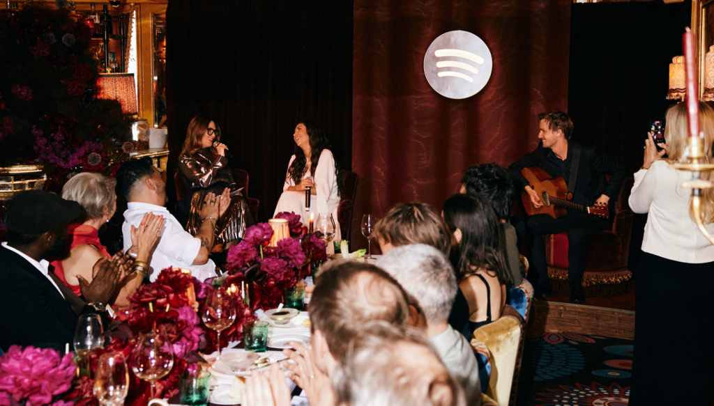 Two people standing at the head of a dinner table