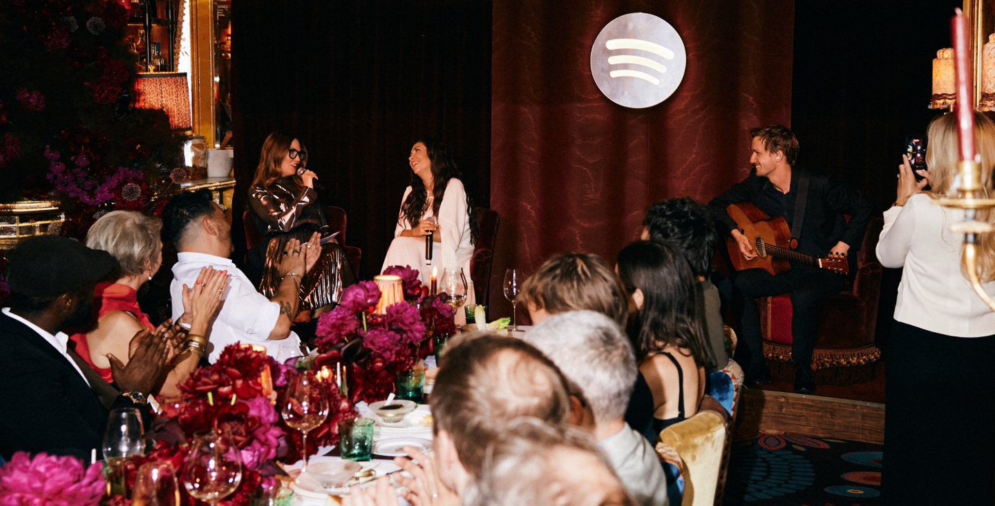 Two people standing at the head of a dinner table