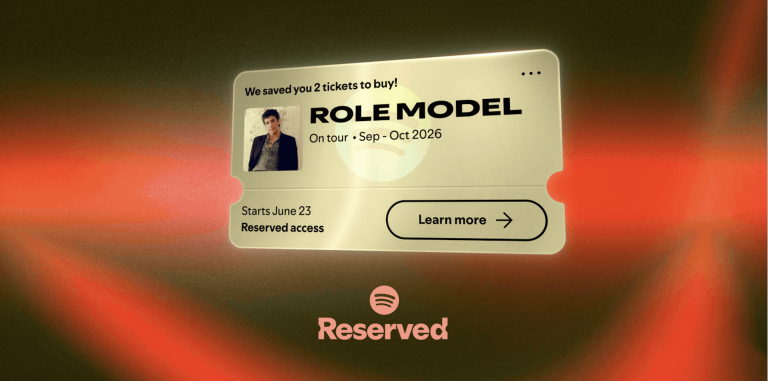 A golden ticket appearing in front of a red, curtain-like backgorund