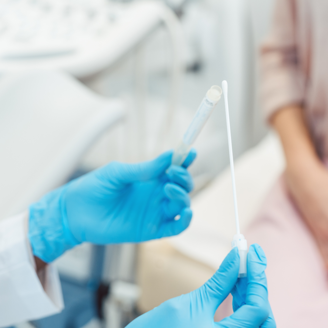 woman having vaginal swab in clinic