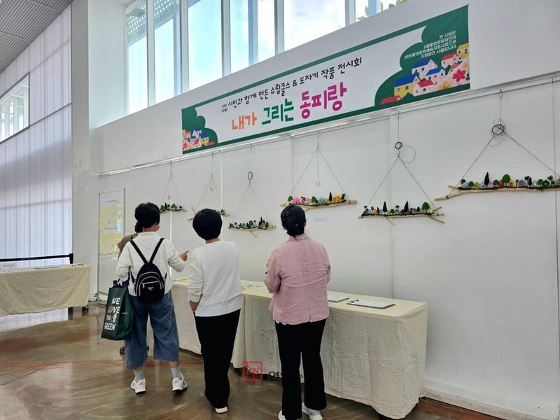 동피랑 벽화를 소재로 한 시민 참여 프로젝트 전시에서 참여자들이 제작한 슈링클스와 도자 공예 작품들이 전시되고 있다. (통영시 제공)
