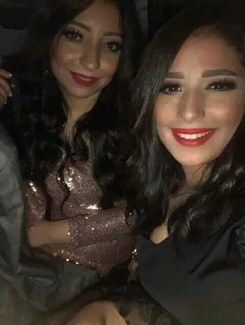 Two Women Taking a Dimly Lit Selfie