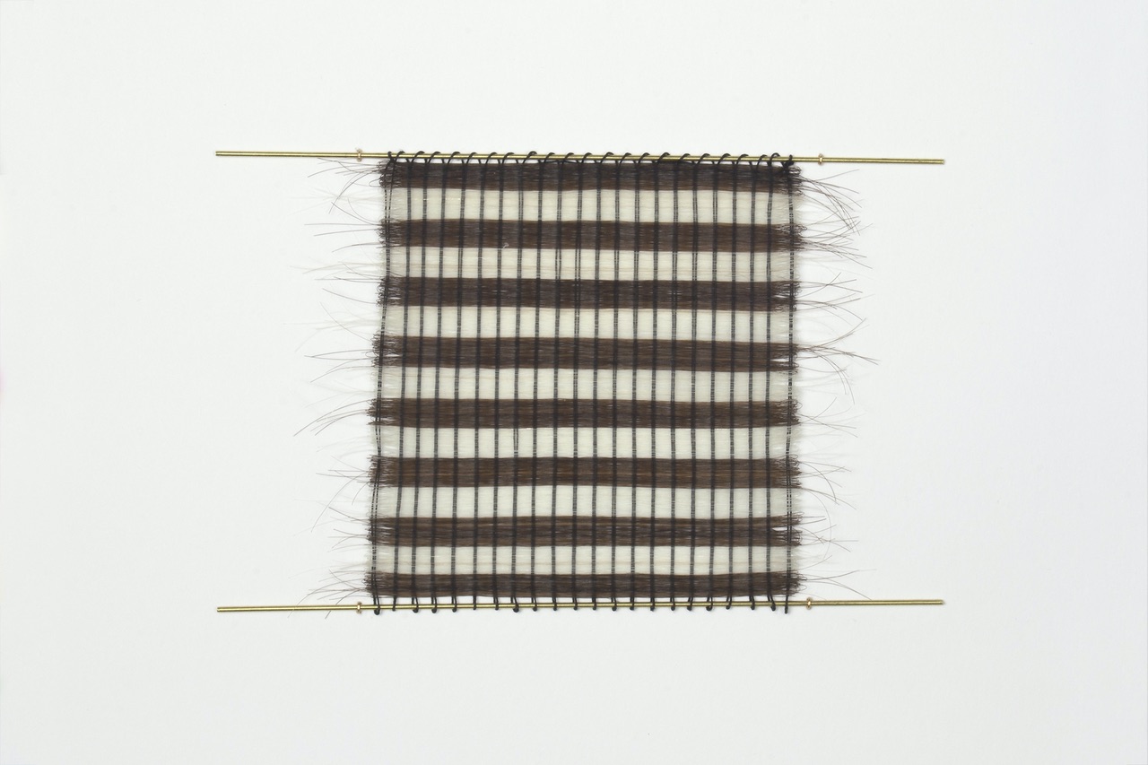 Pin Loom Hair Weave #7, 2020 | artist’s gray and dark hair, silk thread, and brass rods 11.43 x 9.53 cm