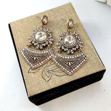 Gold Toned / White Stone Embedded Stylish Danglers For Women