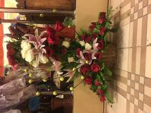 red and white roses with lilly in a basket