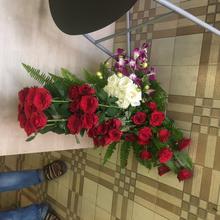 red and white roses with orchid in a basket