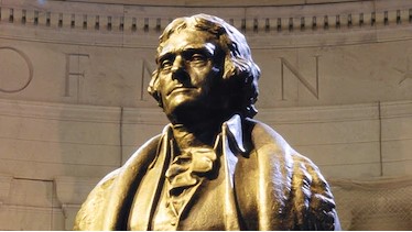 A bronze statue of Thomas Jefferson stands at a memorial in Washington, D.C.