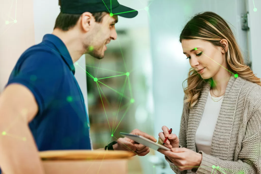 woman signing for delivery from delivery driver green plexus overlayed