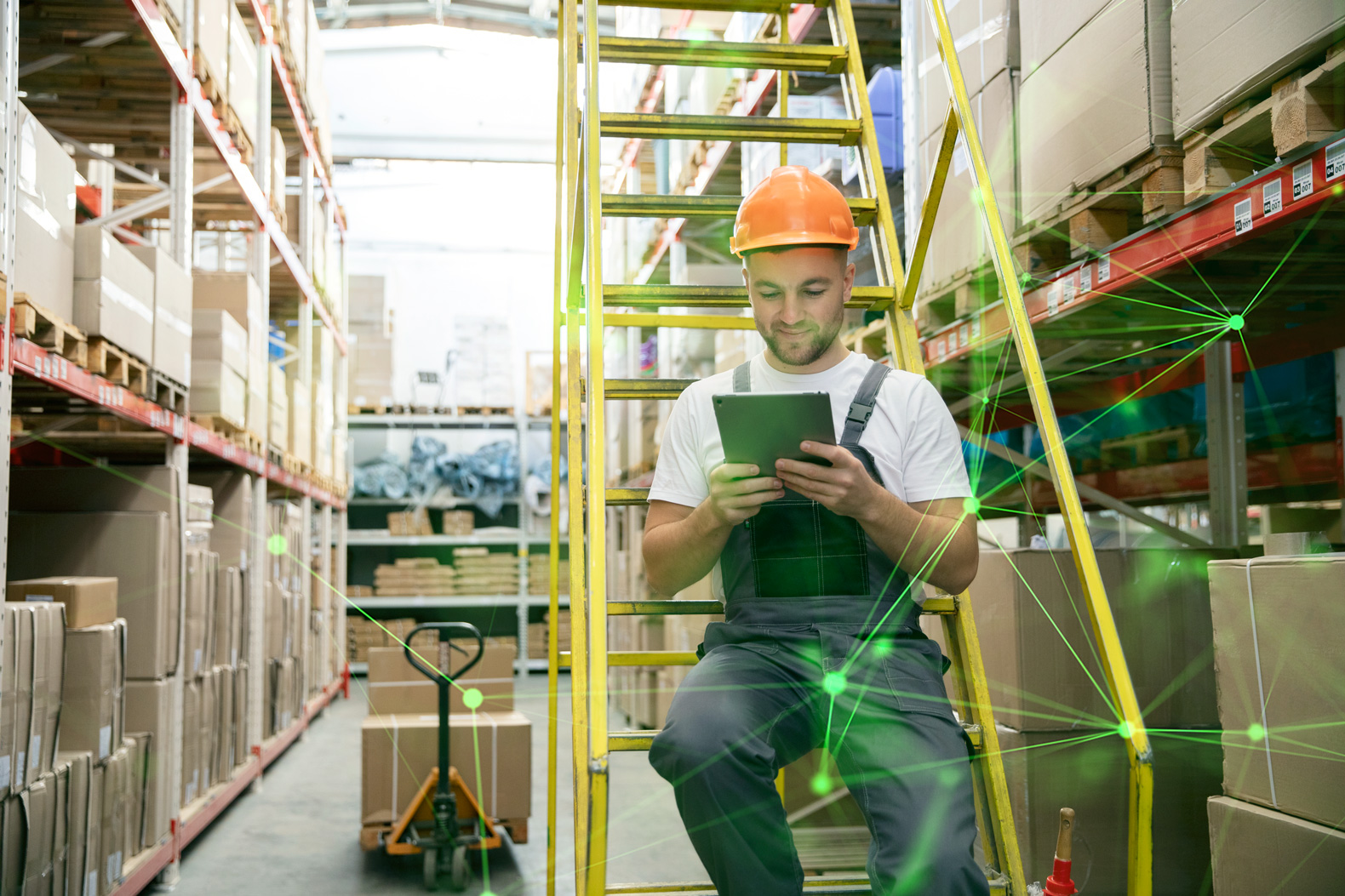 A man in warehouse checking the inventory on his tablet