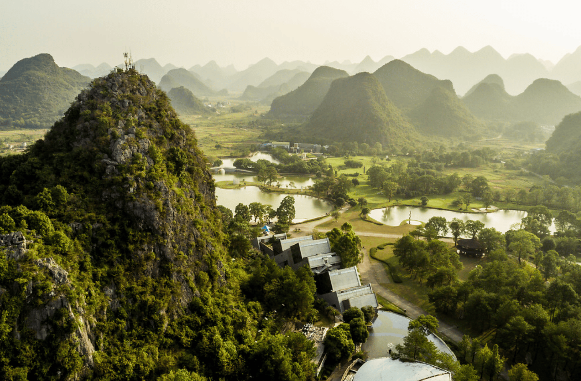 Scenic aerial view of Club Med Guilin resort nestled among iconic karst mountains in Guangxi China