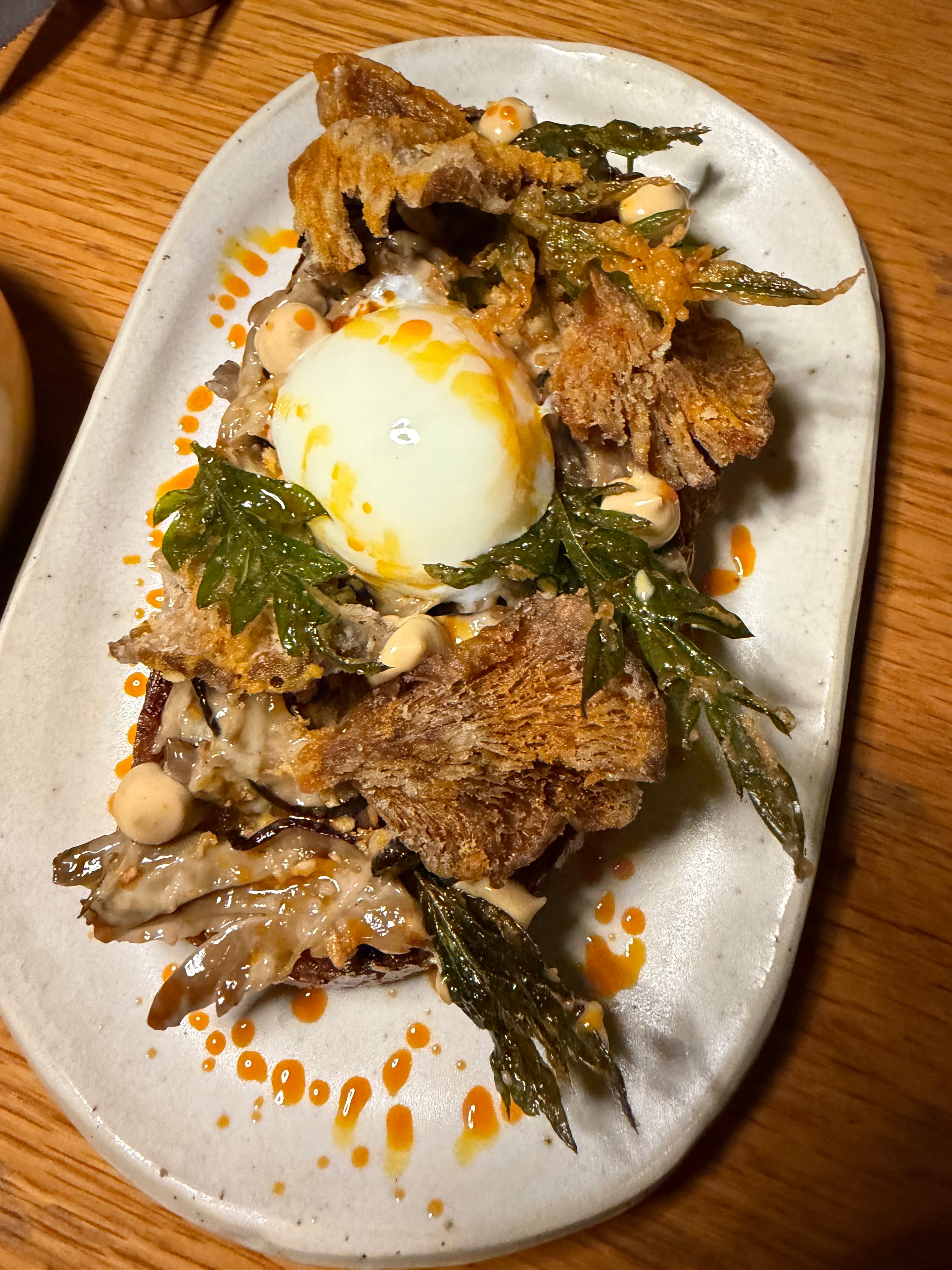 Mushroom Dinakdakan Toast, served on crisp toast with rich and savory flavors.