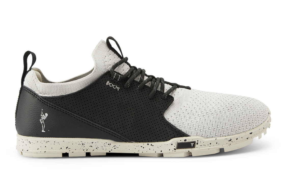 A stylish golf shoe is displayed.