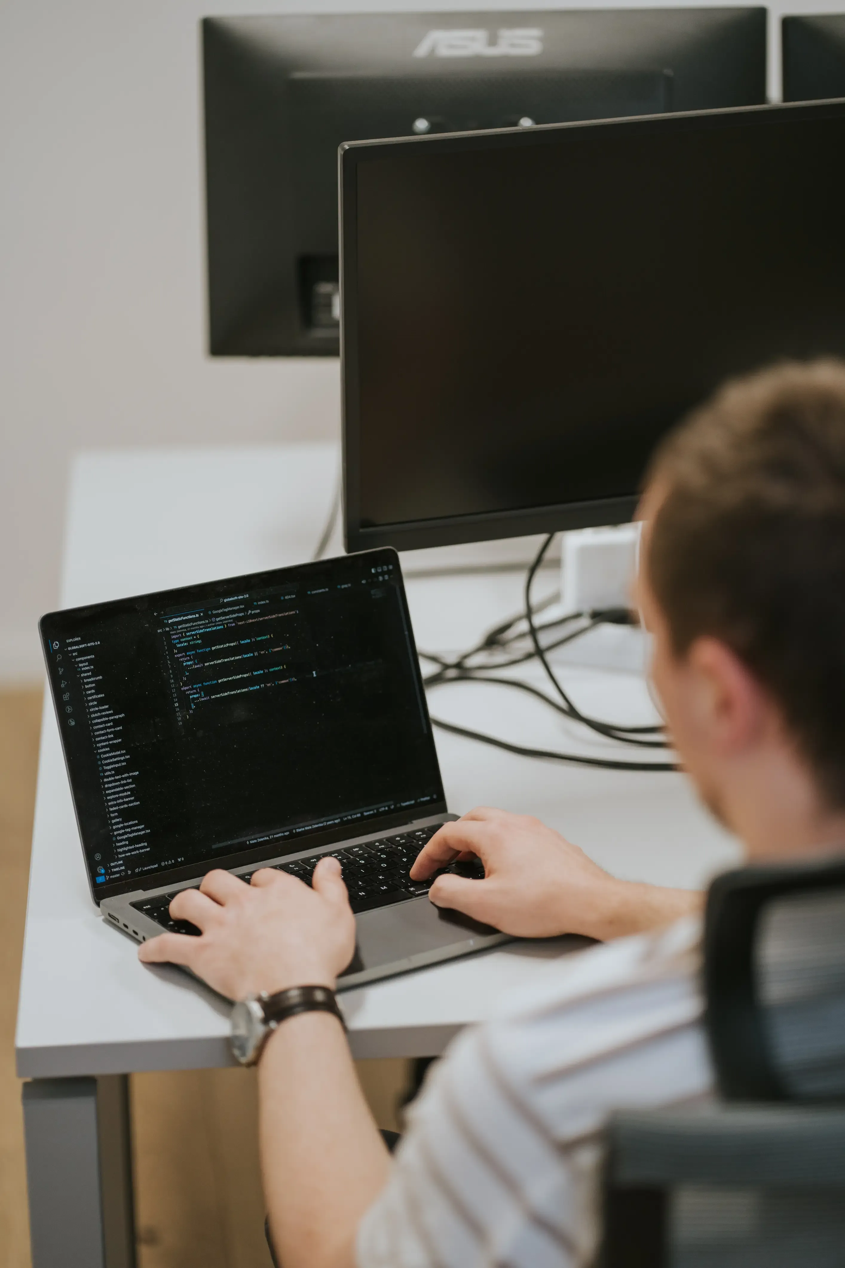 Developer working on code on his laptop