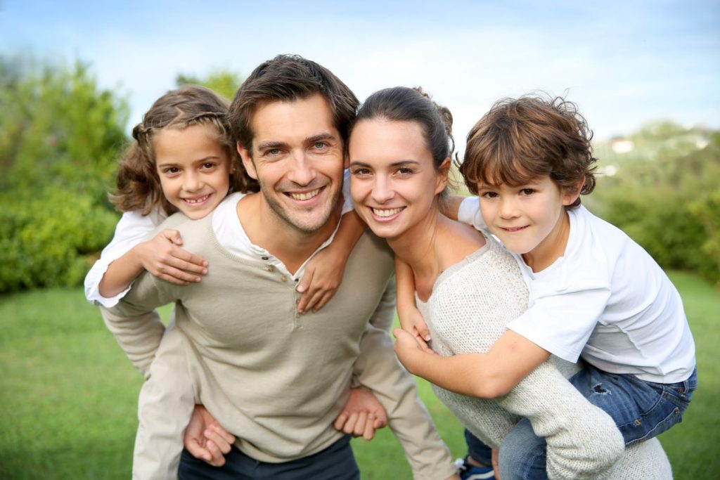 A family with two children is posing in a holding style. In a new study, adult children were less likely to be cut off from their mothers as they had spent the most time with them. EBS PROFESSIONAL VIA SHUTTERSTOCK