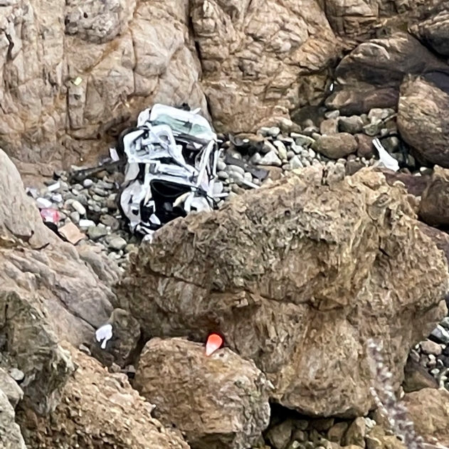 This image from video provided by San Mateo County Sheriff's Office shows a Tesla vehicle that plunged off a Northern California cliff along the Pacific Coast Highway, Monday, Jan. 2, 2023, near an area known as Devil's Slide, leaving four people in critical condition, a fire official said. The vehicle fell about 250 feet (76.20 meters (250.00 feets)) from the highway, the fire official said. Motorists were told to expect delays as rescuers worked. Helicopters were expected to transport four people to hospitals. SAN MATEO COUNTY SHERIFFS/ACCUWEATHER