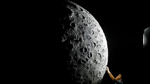 The boy touch to model of moon during Explore CASCI(China Aerospace Science and Cultural Innovation) ART Exhibition on October 2, 2022 in Wuhan, Hubei province, China. (Photo by Getty Images）
