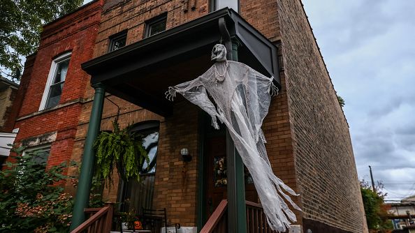 Halloween decorations outside a house in Chicago, United States, on October 16, 2022. A giant ghost model hangs on the outside. BEATA ZAWRZEL/NURPHOTO VIA GETTY IMAGES.