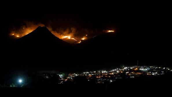 A forest fire in Sierra Arana is seen from Deifontes, a town near Granada, on October 16, 2022. (ÁLEX CAMARA/NURPHOTO VIA GETTY IMAGES)