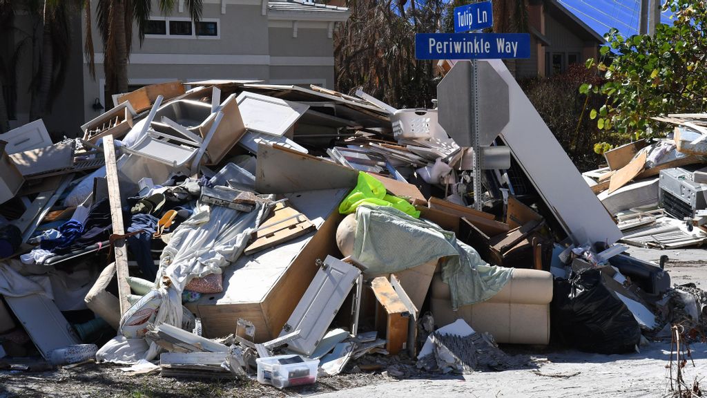 A pile of debris from a home is seen along the road in Sanibel Island, Florida over a month after Hurricane Ian made landfall as a Category 4 hurricane. The storm caused an estimated $67 billion in insured losses and at least 127 storm-related deaths in Florida. PHOTO BY PAUL HENNESSY VIA GETTY IMAGES