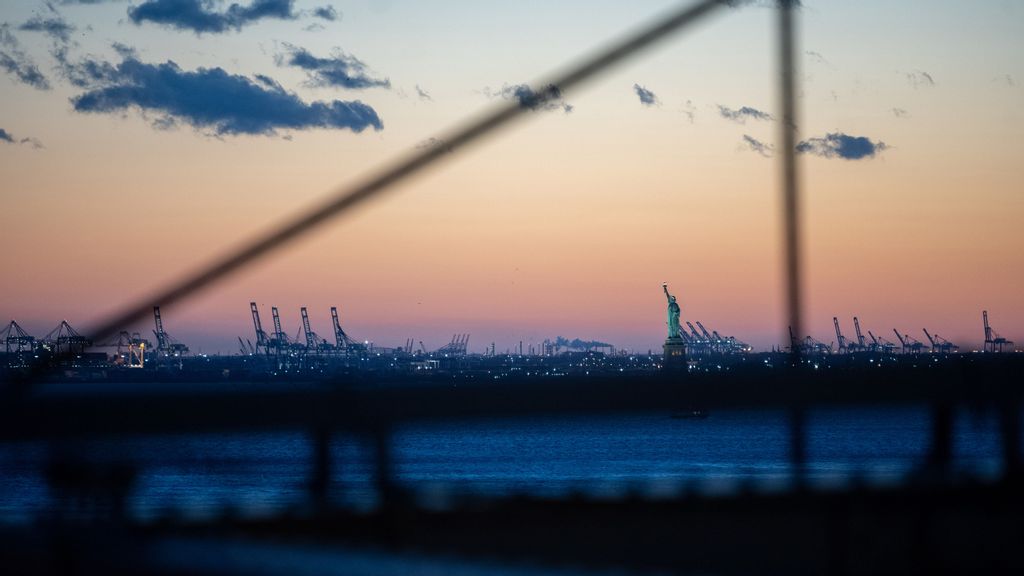 FILE - A view of The Statue of Liberty during the first sunset after the clocks changed for Daylight Savings as seen from the Brooklyn Bridge on March 14, 2021 in the Brooklyn borough of New York City. PHOTO BY ALEXI ROSENFELD VIA GETTY IMAGES