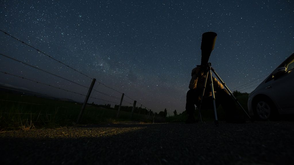 A photographer takes photographs of the blood moon during a total lunar eclipse in Christchurch, New Zealand on November 08, 2022. On Tuesday evening people across Australia and New Zealand could see a total lunar eclipse. The next set of lunar eclipses after this one will be visible from this region on March 14, 2025 according to NASA. PHOTO BY SANKA VIDANAGAMA VIA GETTY IMAGES