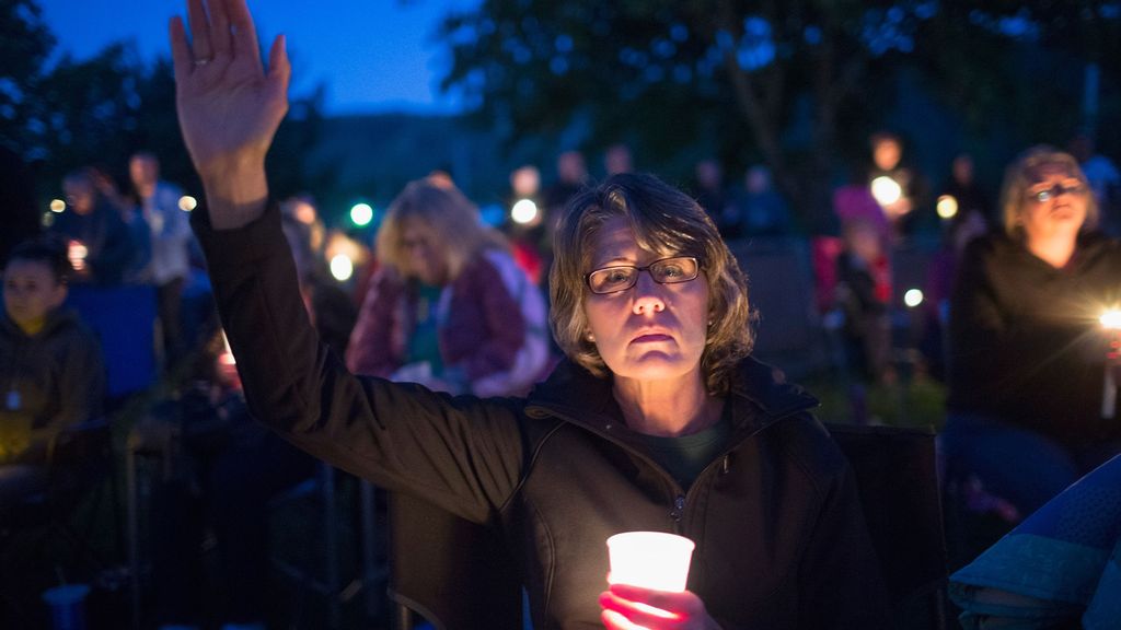 Residents of Douglas County attend a prayer service and candlelight vigil at River Bend Park to remember the victims of the mass shooting at Umpqua Community College in nearby Roseburg. Photo by  SCOTT OLSON VIA GETTY IMAGES 