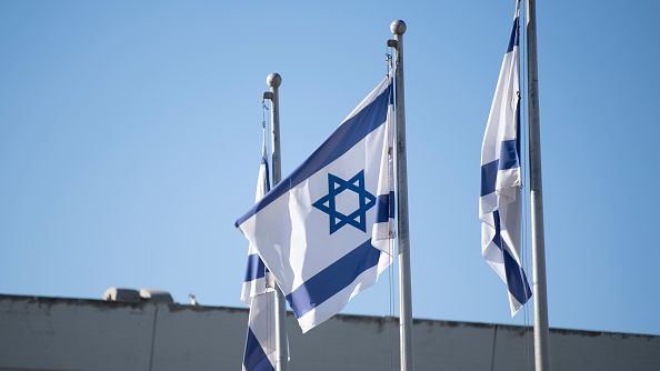 Israeli flags are flying in front of the Knesset in Jerusalem, Israel, on September 11, 2022. Many Israeli leaders think that the conversion ruling will estrange Israel from its diaspora. CHRISTOPHE GATEAU/DPA/PICTURE ALLIANCE VIA GETTY IMAGES 